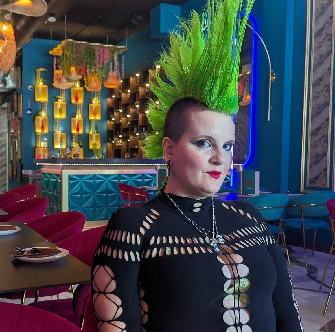 Strugglebus (Kayla), Assistant Director and DJ at Asylum Windsor, with a bold green mohawk